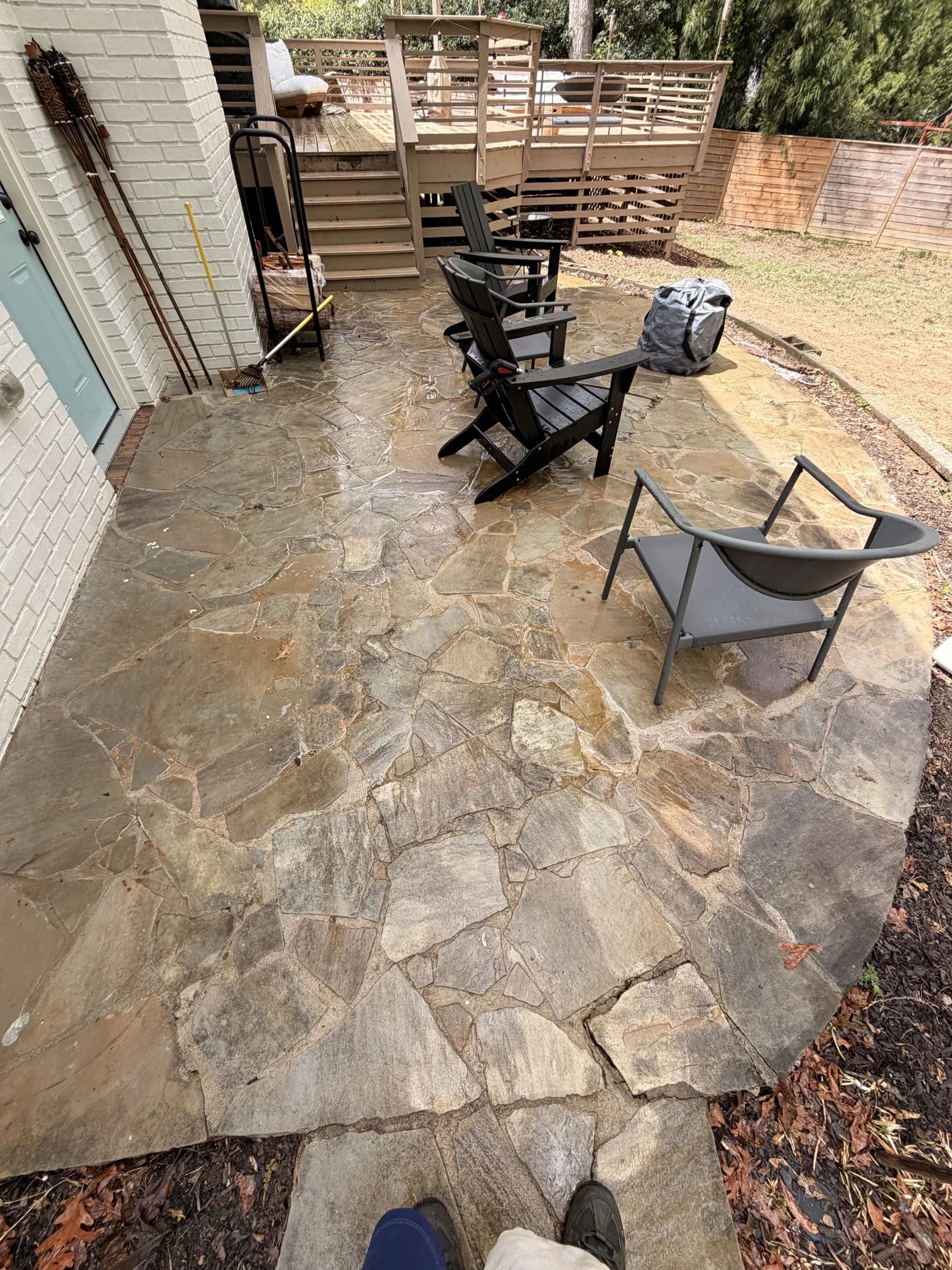 Stone patio and deck area during pressure washing