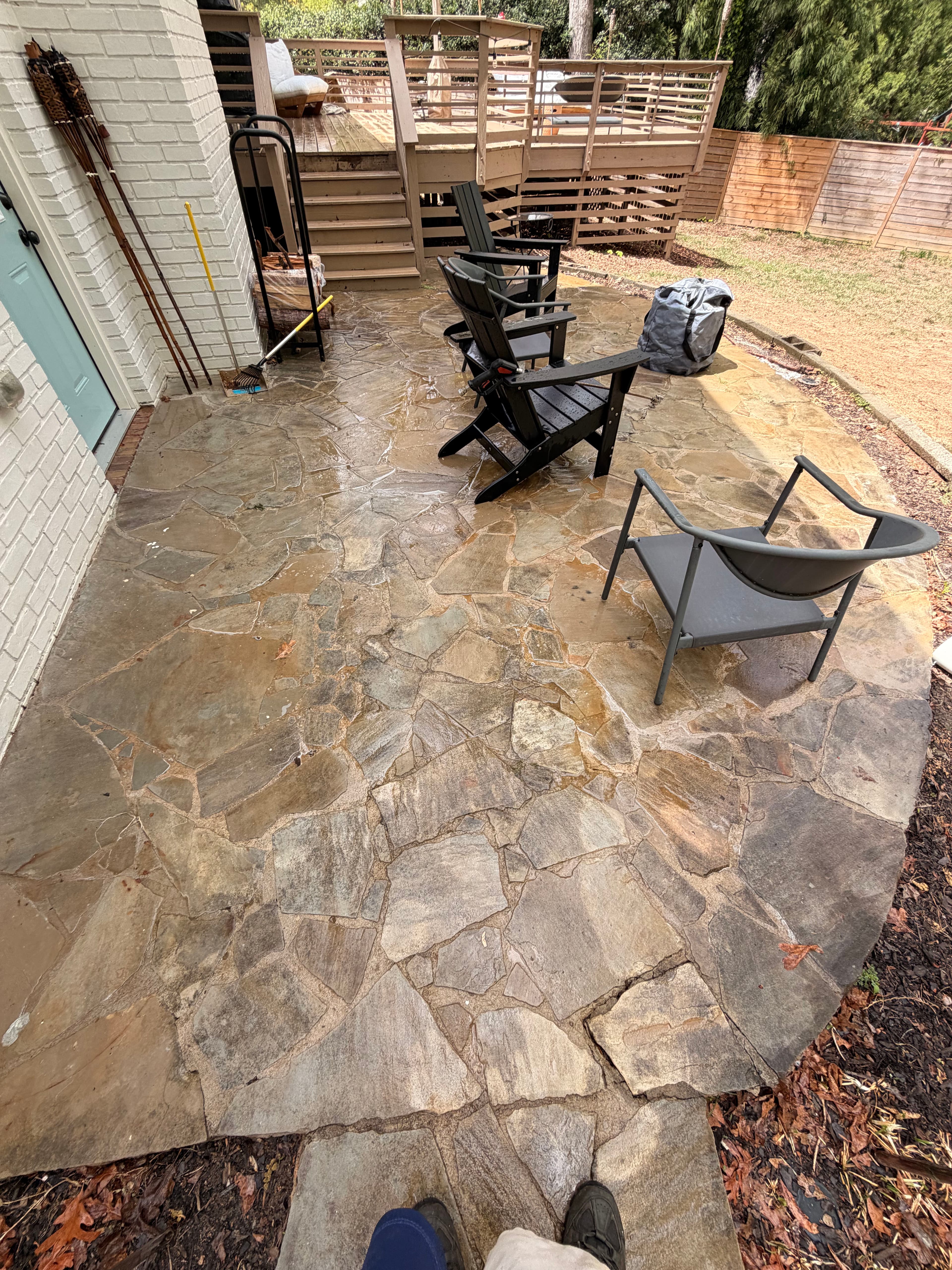 Stone patio and deck area during pressure washing